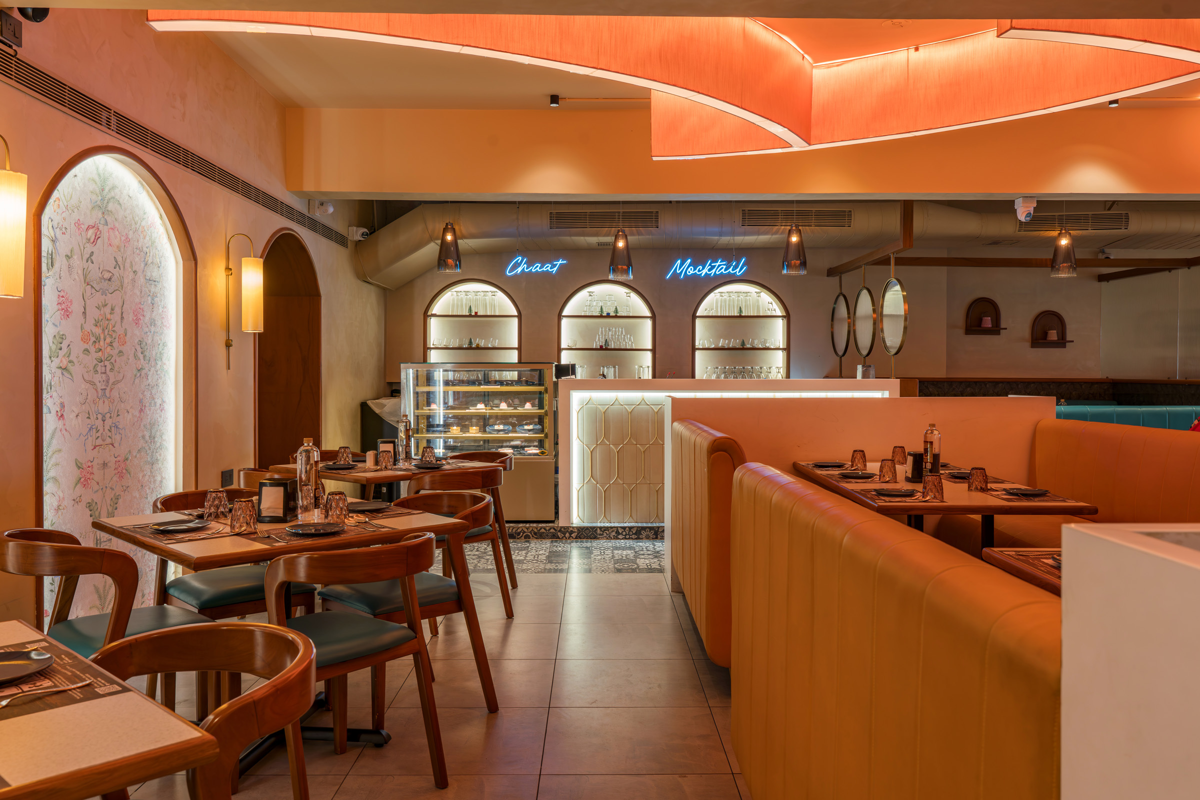 Signature arched alcove seating with terracotta and teal interiors — 4 Cups Restaurant, Coimbatore