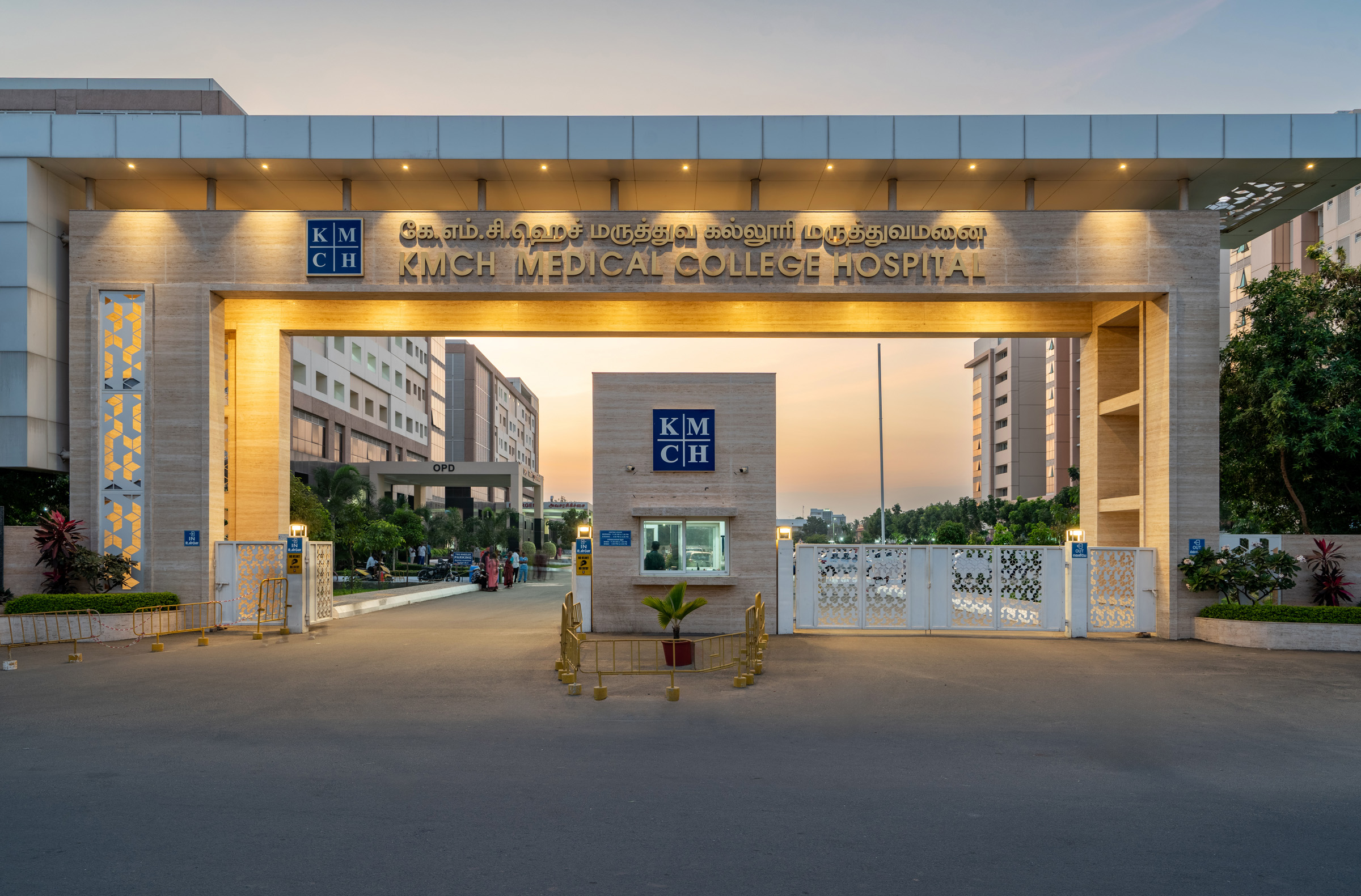 KMCH Hospital illuminated entrance facade at dusk — Coimbatore