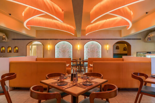 Dining floor with ambient orange lighting and full seating — 4 Cups Restaurant, Coimbatore