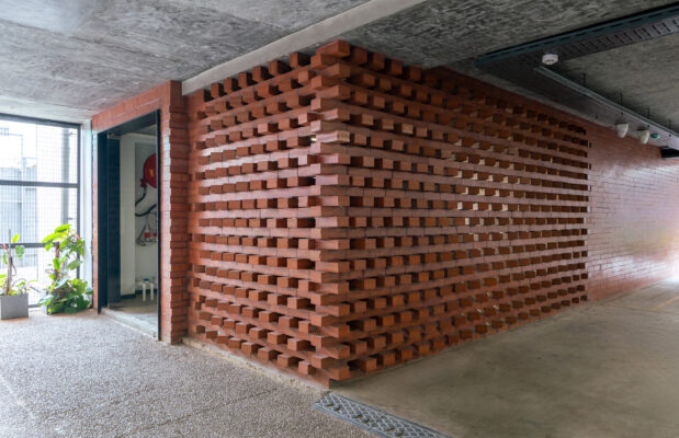Exposed brick textured wall detail — Cuboid interior, Coimbatore