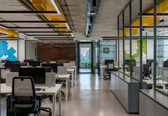 Meeting room with glass partition and yellow chairs — Cuboid, Coimbatore