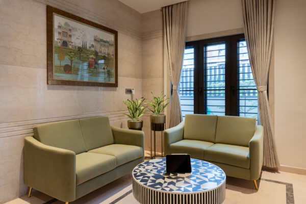 Elegant living room with sofa seating and artwork — Dr. Subramaniam House, Namakkal