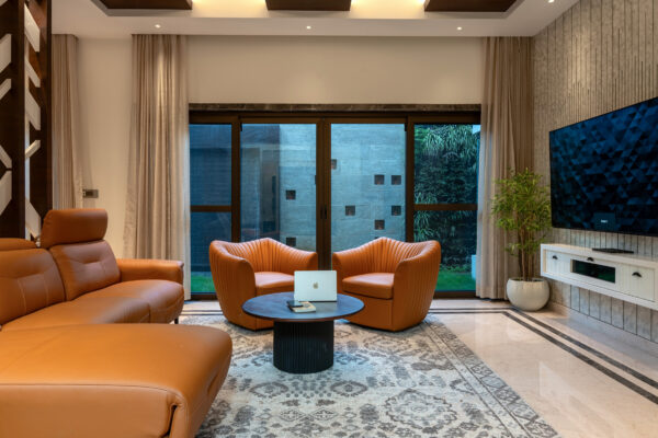 Lounge seating area with warm toned interiors — Dr. Subramaniam House, Namakkal