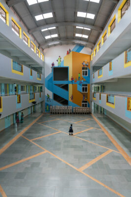 Colourful corridor with blue and yellow accents — Elgi School, Coimbatore
