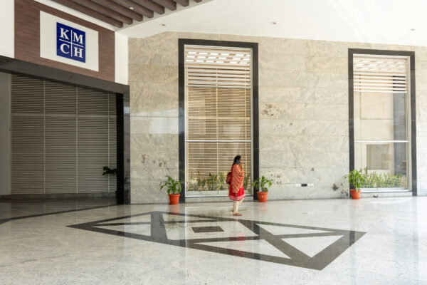 Hospital entrance lobby with glass facade — KMCH, Coimbatore