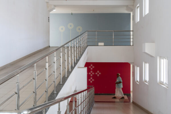 Interior staircase with red accent wall — KMCH, Coimbatore